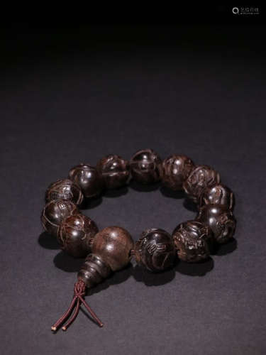A Chinese Eaglewood Carved Beads Hand String