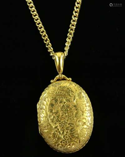 Victorian oval gilt metal locket, with engraved floral motif, including grapes, roses, forget-me-