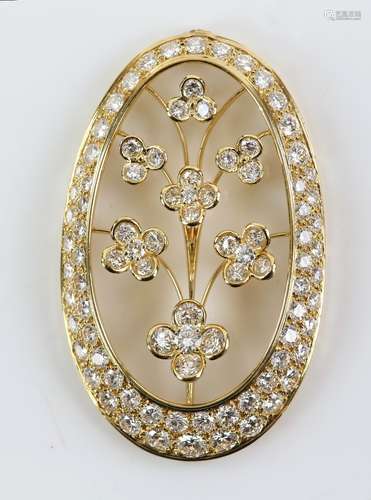 Diamond set pendant, in oval form with central floral motif, set with round brilliant cut