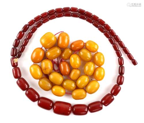 Red Bakelite graduated necklace measuring 82cm in length together with another amber-coloured bead