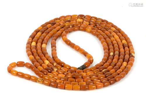 Long amber necklace, cylindrical beads, strung without knots, with a base metal twist clasp, 224cm