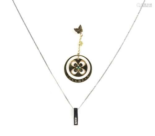 Zoughaib pendant with central flower motif and butterfly bale, stamped 18 ct and another