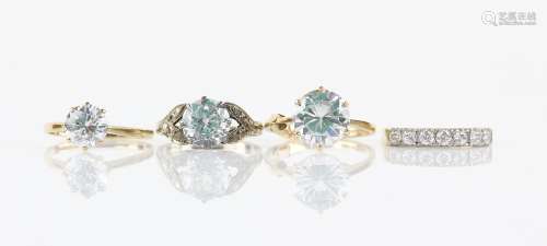 Four cubic zirconia rings, one single stone set in eight claw mount, ring size P 1/2, another
