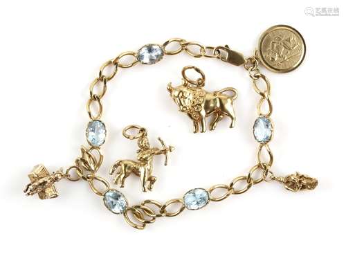 Gold charm bracelet, curb links alternately set with five oval cut blue topaz, lobster claw clasp,