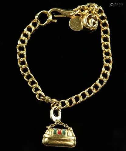 Gucci gold charm bracelet, fancy curb links, with round Gucci charm, spherical logo charm and a