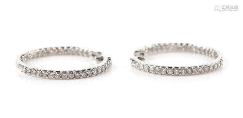 Modern diamond hoops, claw set round brilliant cut diamonds, estimated total diamond weight 1.40