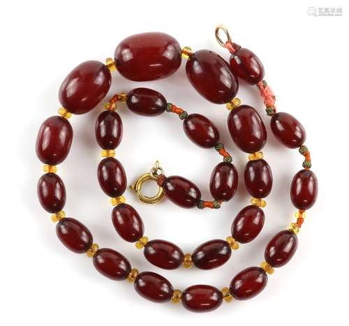 A mixed group of jewellery, including a graduated Bakelite necklace 42cm in length, four strand