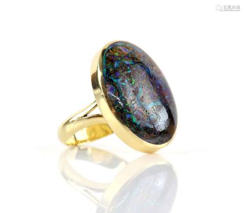 Contemporary boulder opal ring, an oval cut cabochon, 17 x 24mm, in 18 ct yellow gold, hallmarked
