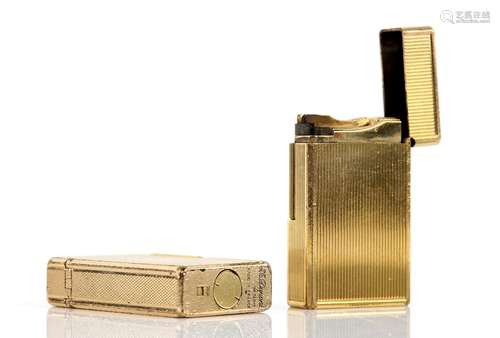 Two S. T. Dupont gilt metal lighters; one with reeded decoration No.9416CP, the other with a diamond