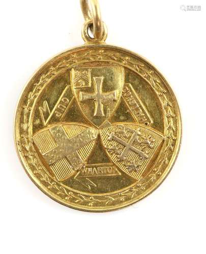 A gold sporting medallion with jump ring, engraved and testing as 18 ct, total weight 14.1 g..