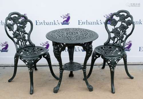 Cast iron circular garden table, with pierced floral decoration on legs cast with Britannia, on