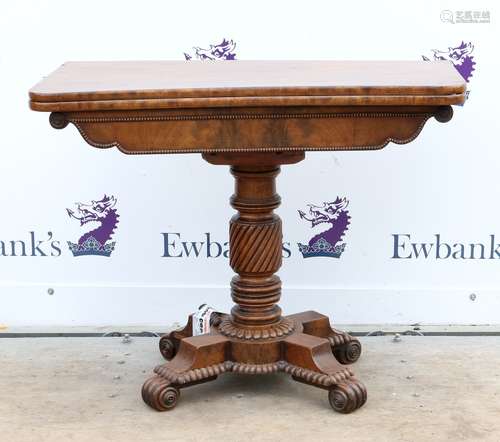 19th century mahogany fold over tea table, on turned column, quatrefoil base and scroll feet, 73cm