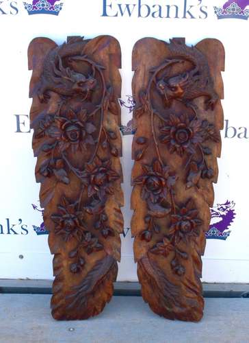 Pair of Chinese hardwood wall panels, relief carved with dragons and flowers, 30 x 98cm