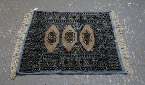 Bokhara type blue ground rug with three medallions and multiple borders, 68cm x 60cm,