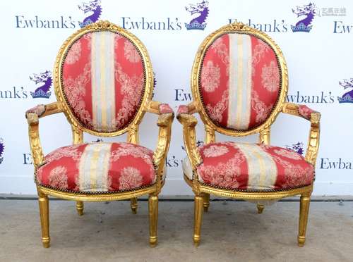 Pair of 19th century French giltwood fauteuils, with oval backs, floral carving and striped floral