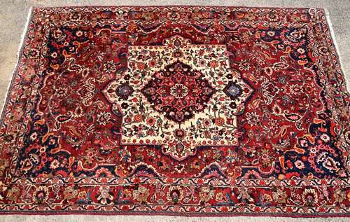 Persian Bakhtiari type red ground carpet, with multiple borders, the centre with a cream medallion