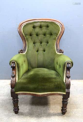 Victorian rosewood framed button backed armchair with carved back rail and arms on turned and carved