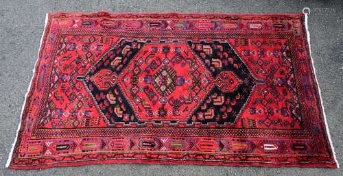 Persian style red ground rug, with central medallion and multiple borders, 237cm x 139cm,