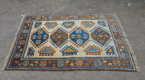 Kazak cream ground rug with hooked shaped medallions, 175cm x 129cm