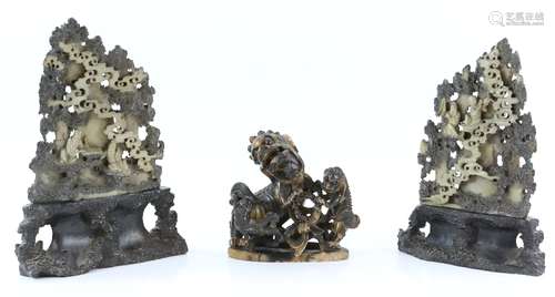 Three Chinese soapstone sculpture, comprising: two carved as Scholars in a mountainous retreat,