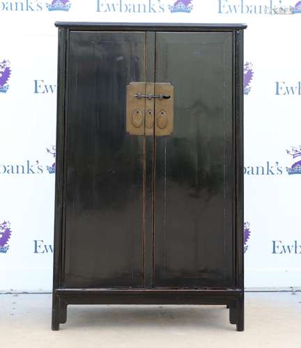 A Chinese black lacquer cabinet of typical trapezoid form with metal fittings, 82 x 42 x 135 cm,