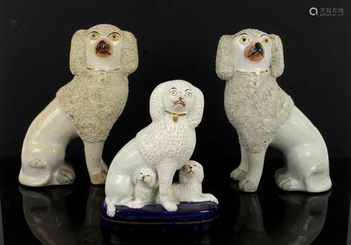 Two 19th Century Staffordshire partly encrusted seated Poodles, h23cm, and a figural group of Poodle