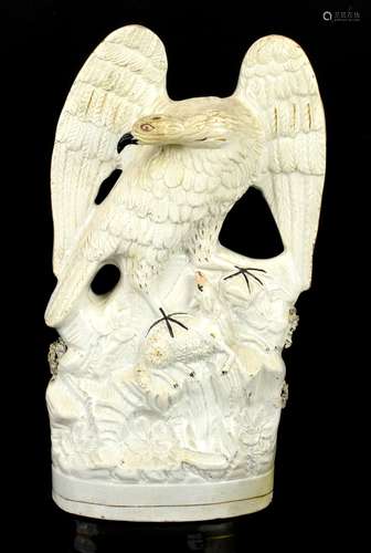 Unusual Staffordshire group of an eagle landing on a lamb, the base moulded as flowers, in white