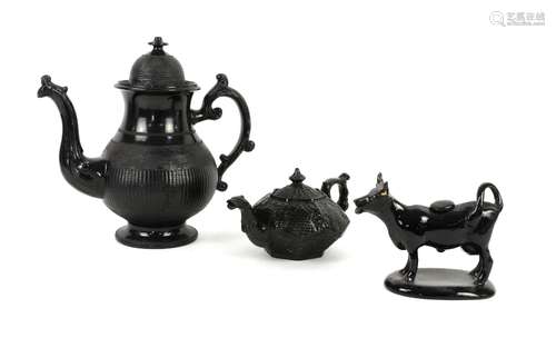 Jackfield black glazed cow creamer circa 1870, an Egyptian black glazed seven-sided bachelor