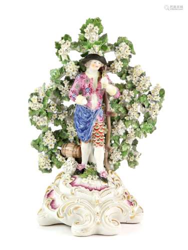 Derby male harvester figure with bocage background, 18th century, on pink and gilt rococo base, 28cm