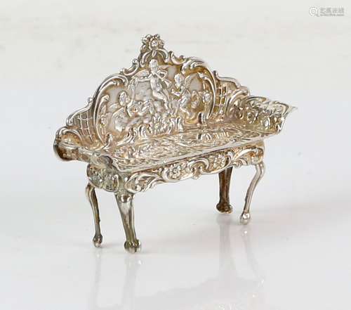 Modern silver model of a sofa with putti or cherub decoration, by DJS, London, 1974, 6.2 cm wide, 17