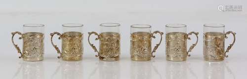 George V set of six silver sleeved highly embossed cups, with rural and municipal scenes, by James