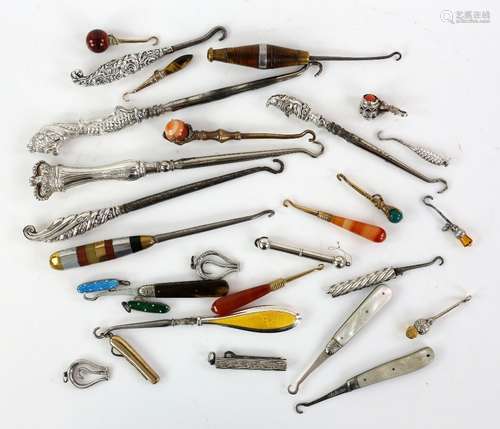 A collection of silver-handled button and glove hooks, including a Mr Punch hook by Crisford &