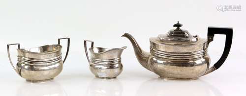 Edward VII three piece silver tea service of compressed oval form, comprising teapot, sugar bowl and