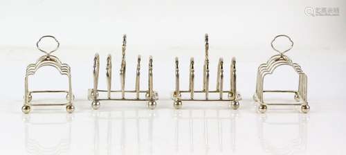 George V set of four silver toast racks, each four-divide racks on ball feet, by Henry Atkin,