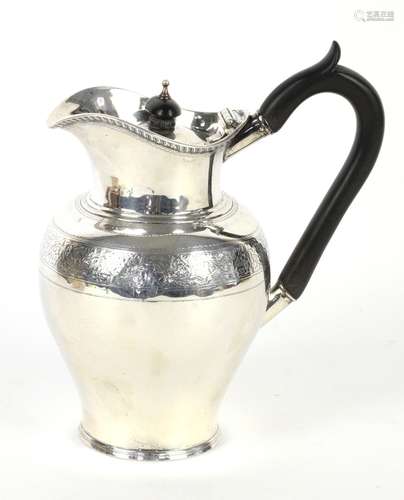 Victorian silver jug, the baluster body with chased foliate band and everted lip, by Henry Gee &