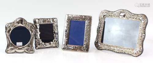 Four modern silver-mounted frames including two decorated with children's toys, one larger frame