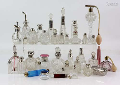 Large collection of silver and white-metal mounted cut glass and other scent bottles, including a