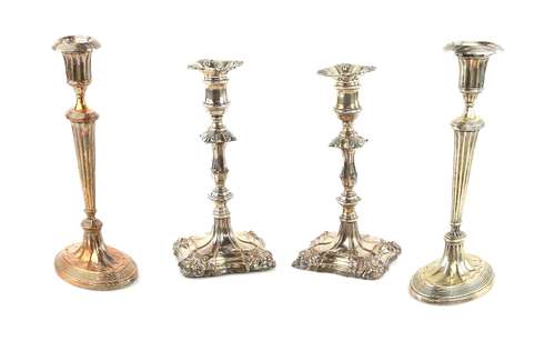 Pair of silver-plated candlesticks, on oval reeded bases and stems, 27cm high and another pair in