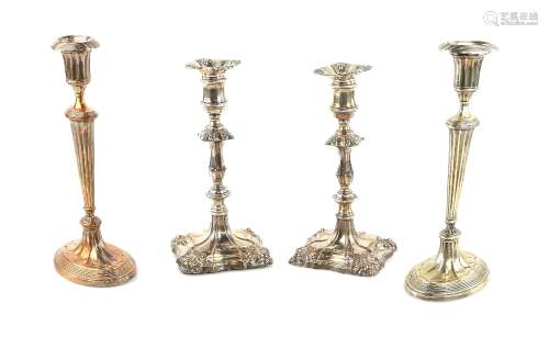 Pair of silver-plated candlesticks, on oval reeded bases and stems, 27cm high and another pair in