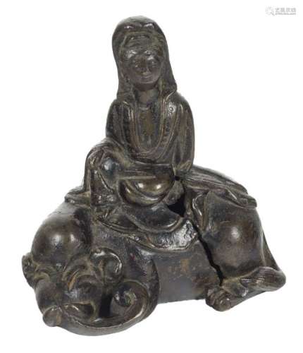 A small bronze figure of a Guanyin seated on a myt…