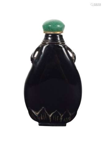 A carved dark red amber snuff bottle. China. Qing …
