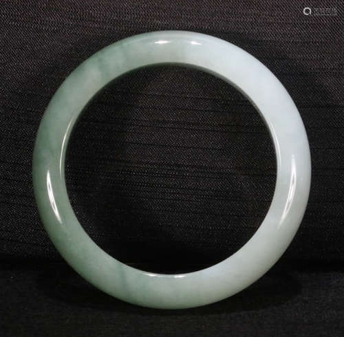 A JADEITE CARVED BANGLE