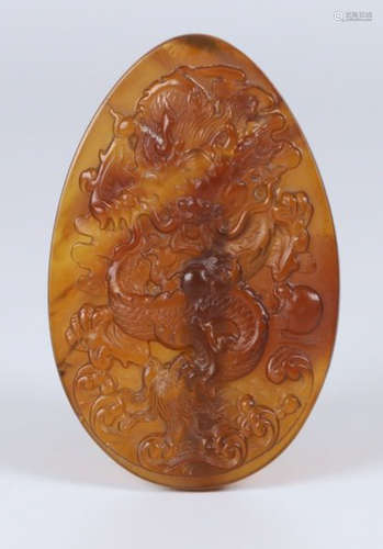 AN AMBER TABLET CARVED WITH DRAGON PATTERN