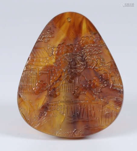 AN AMBER TABLET CARVED WITH FIGURE STORY