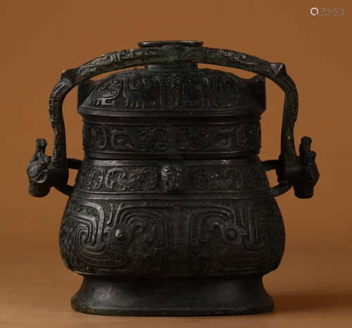 A COPPER POT WITH CARVING