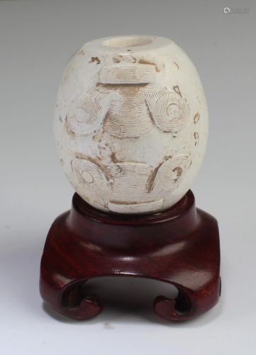 A Carved Jadestone Ornament with Stand