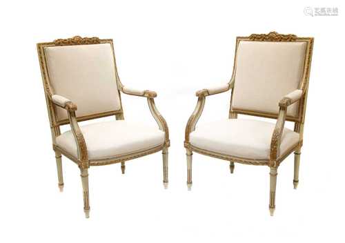 A pair of Louis XVI-style gilded and grey painted wood armchairs,