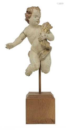 A carved fruitwood and painted figure of a putto,