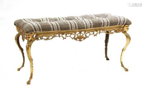 A gilt brass and button upholstered stool,