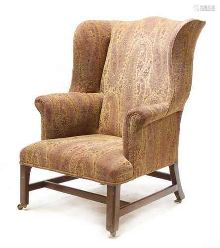 A George III mahogany wingback armchair,